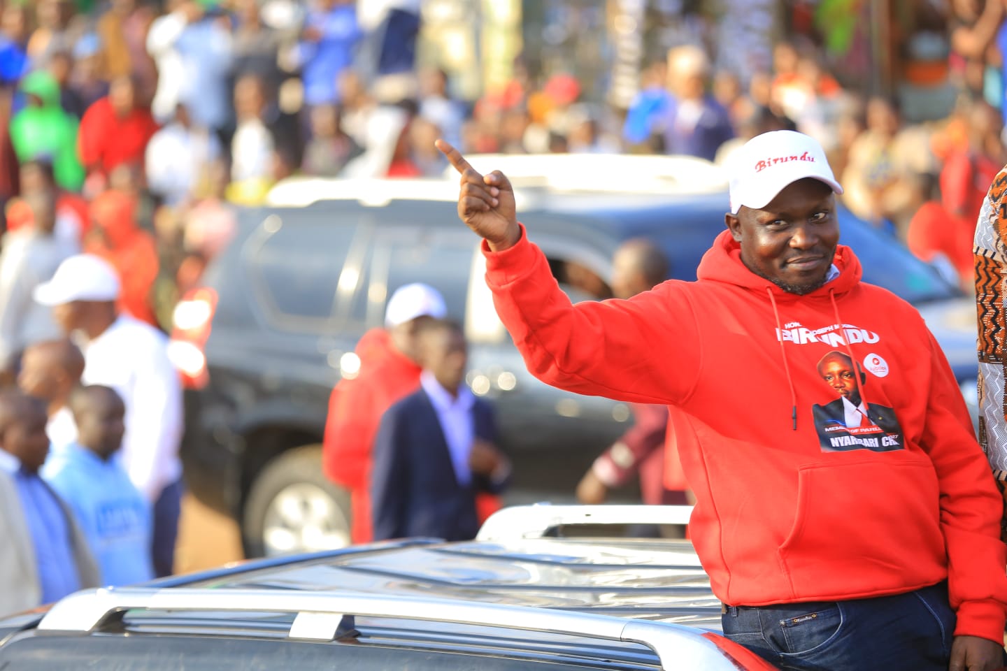 Dr. Birundu greeting a large crowd of supporters